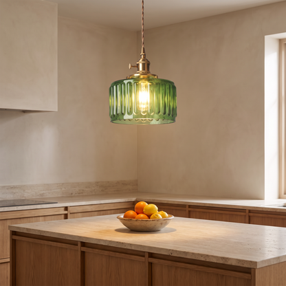 Green glass pendant above a kitchen island