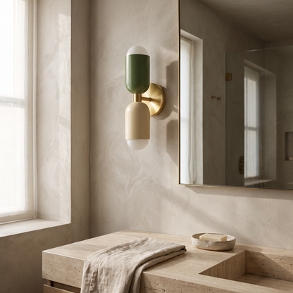 Dual bulb wall lamp beside a bathroom mirror