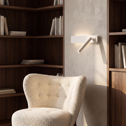 Reading arm wall light beside a study armchair