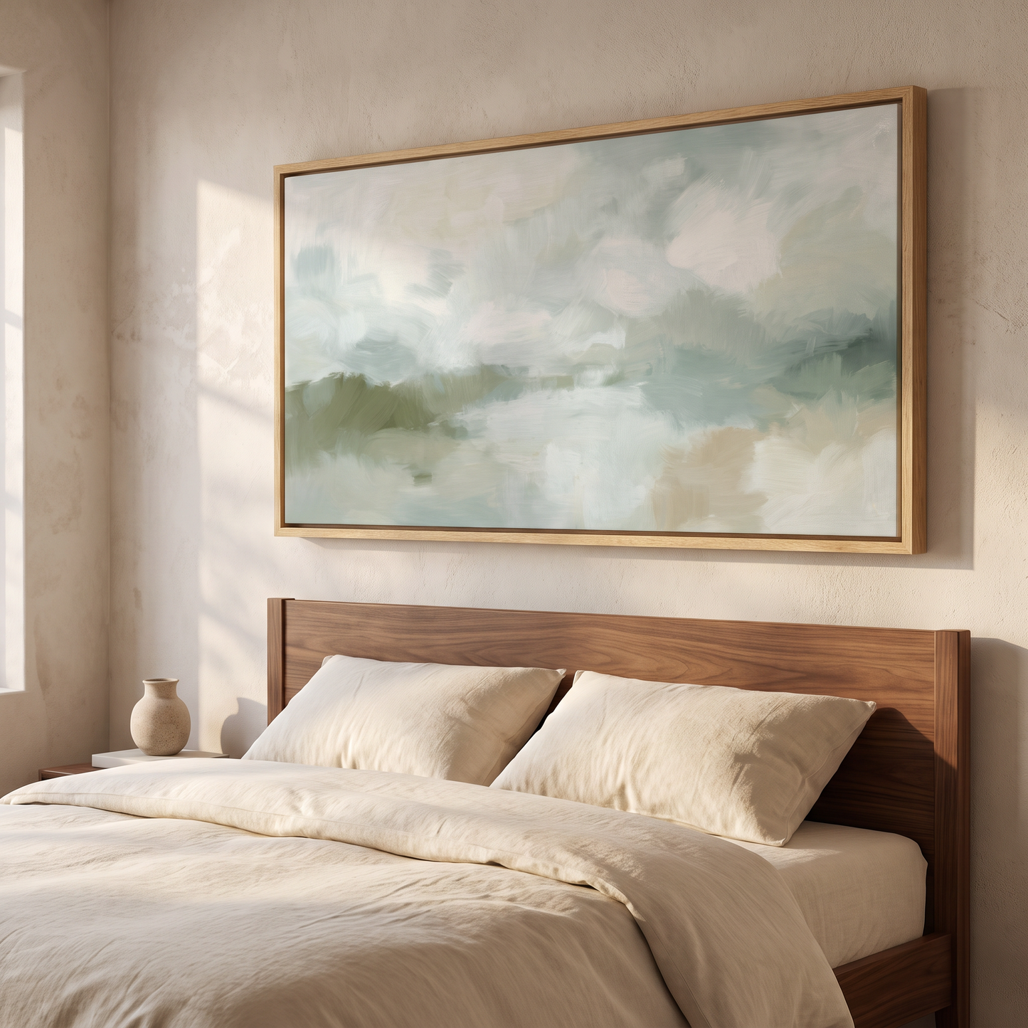 Framed canvas above a bed in a minimalist bedroom