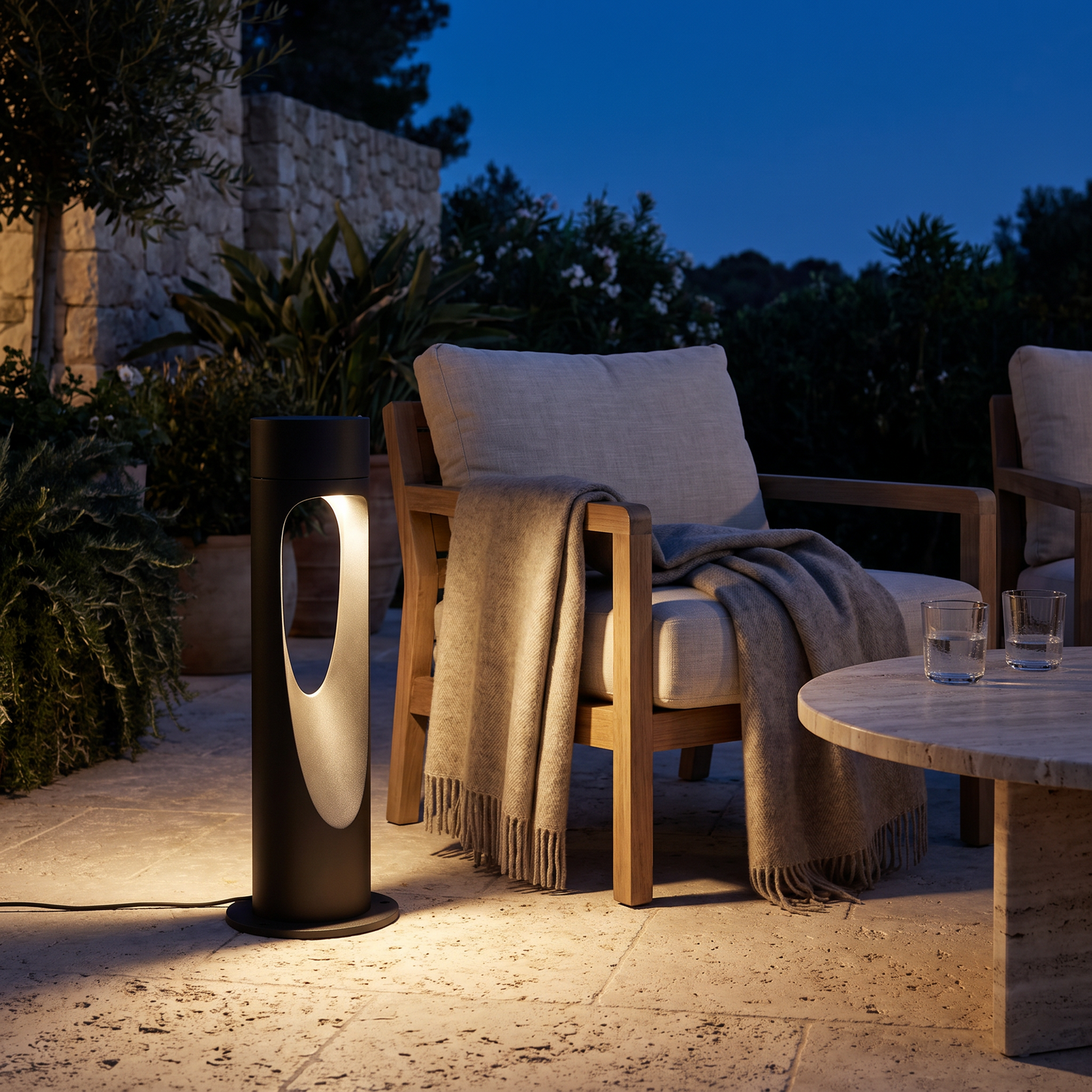 Outdoor floor lamp glowing on a terrace at night